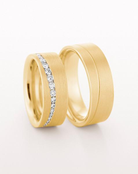 YELLOW GOLD FLAT WEDDING RING WITH CURVED LINE OF TAPERED DIAMONDS 75MM - RING ON LEFT